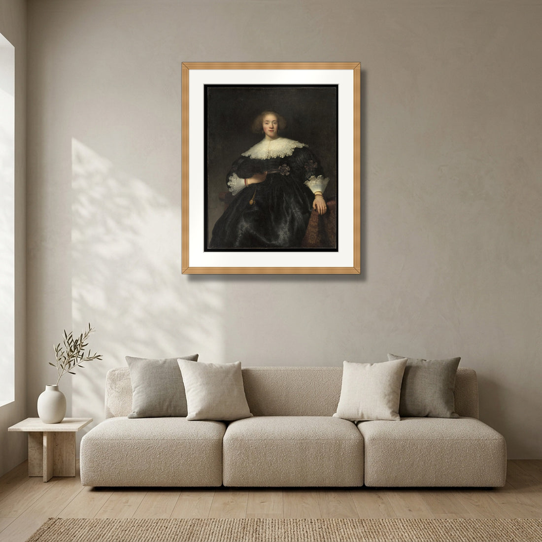 Portrait of a Young Woman with a Fan (1633) – Rembrandt van Rijn framed in solid natural oak in a modern living room